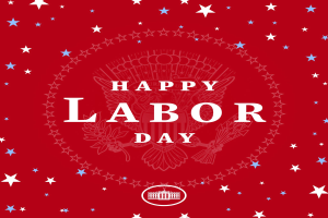 Plakat mit "Glücklicher Arbeitstag" in fetten weißen Buchstaben auf einem hellroten Hintergrund, umgeben von farbigen Sternen verschiedener Größen.